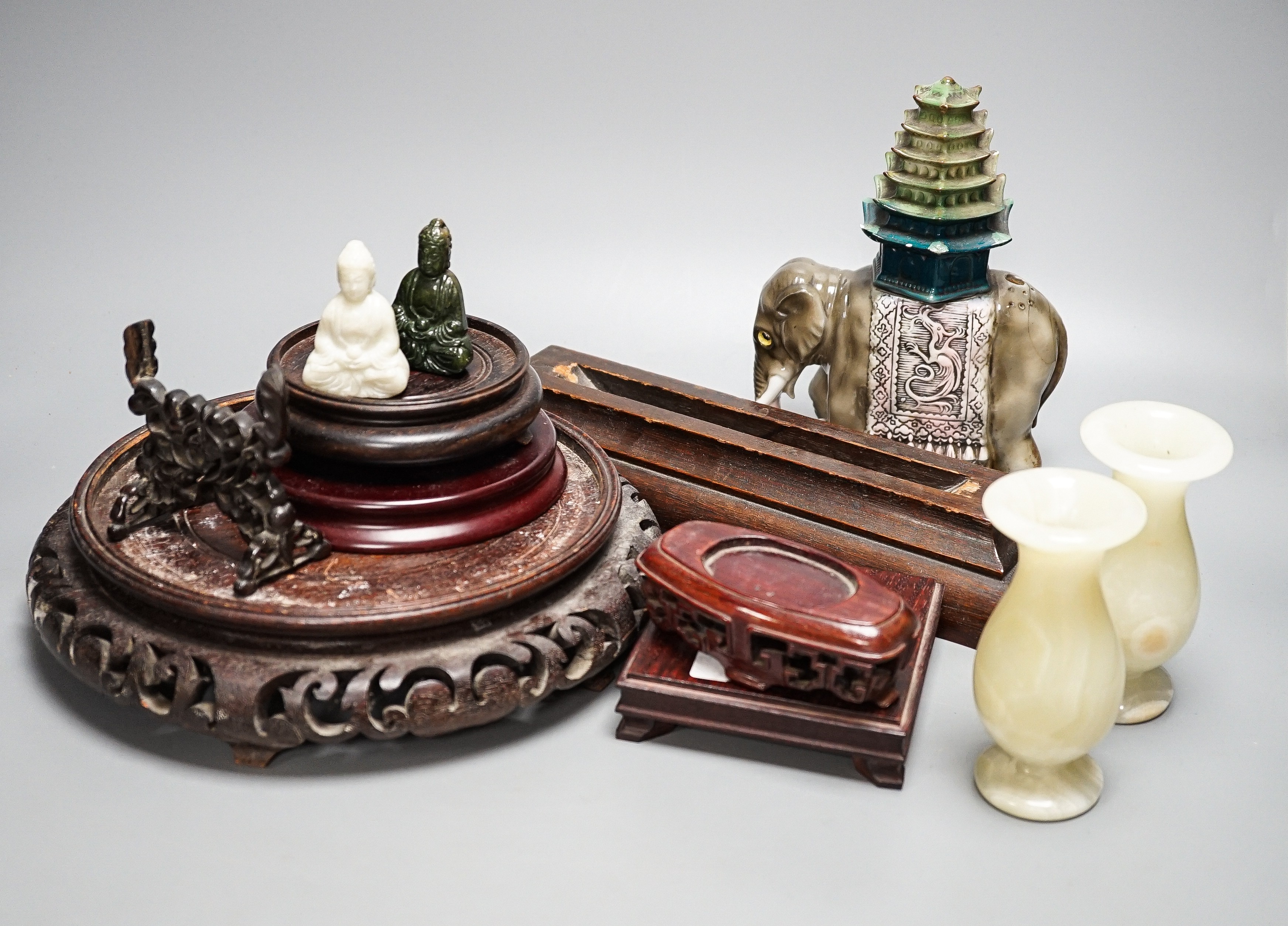 A pair of hard stone vases, 2 hard stone figural carvings, a porcelain elephant, and a quantity of hardwood stands
